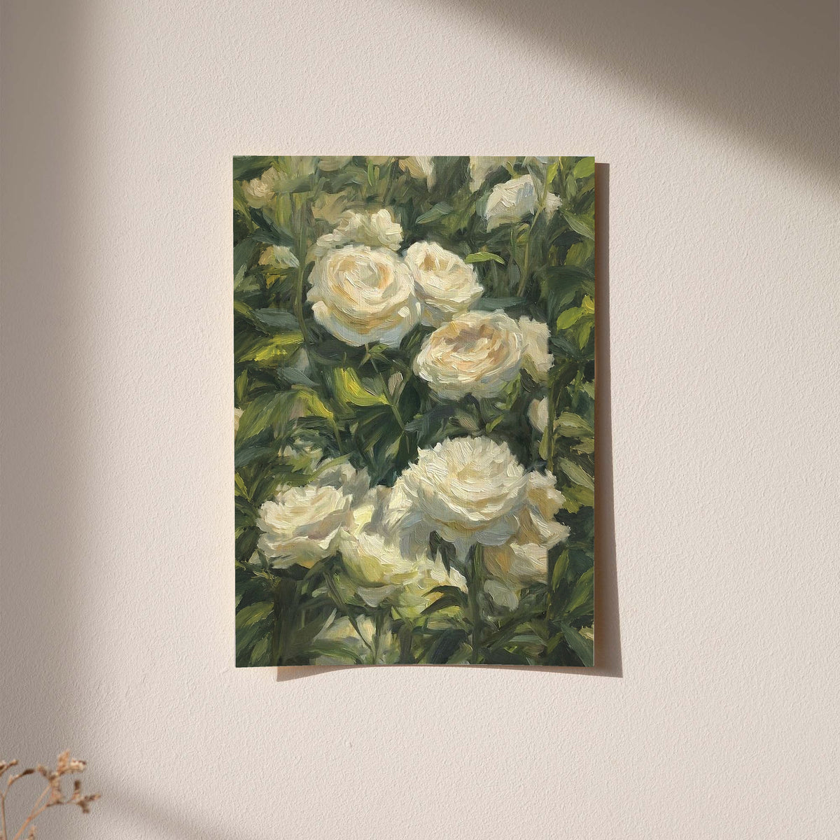 Cream white roses among dense green garden foliage in a painterly composition as an unframed hanging paper print against a plaster wall