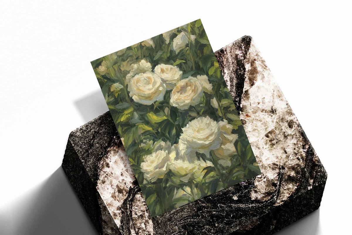 Cream white roses among dense green garden foliage in a painterly composition as an unframed print standing on a stone plinth against white