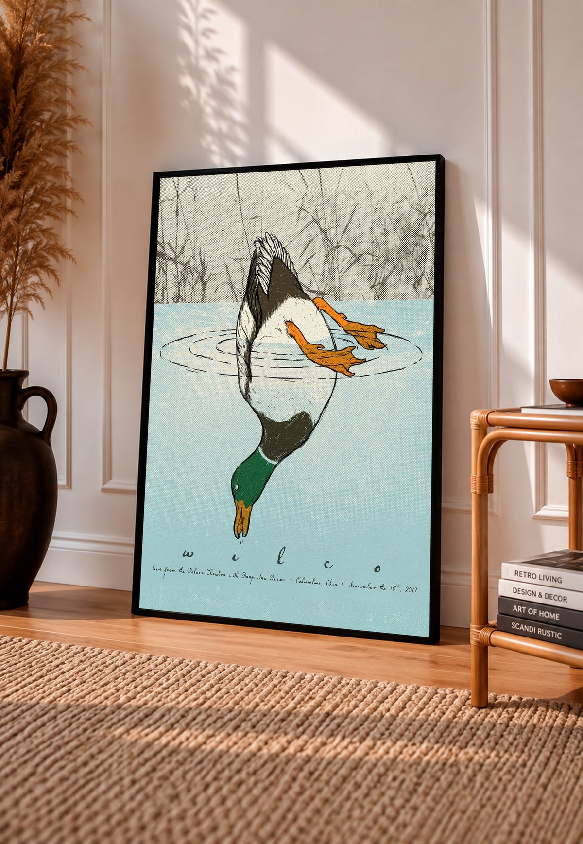 Black-framed diving duck art print with blue water and small fish, wall decor