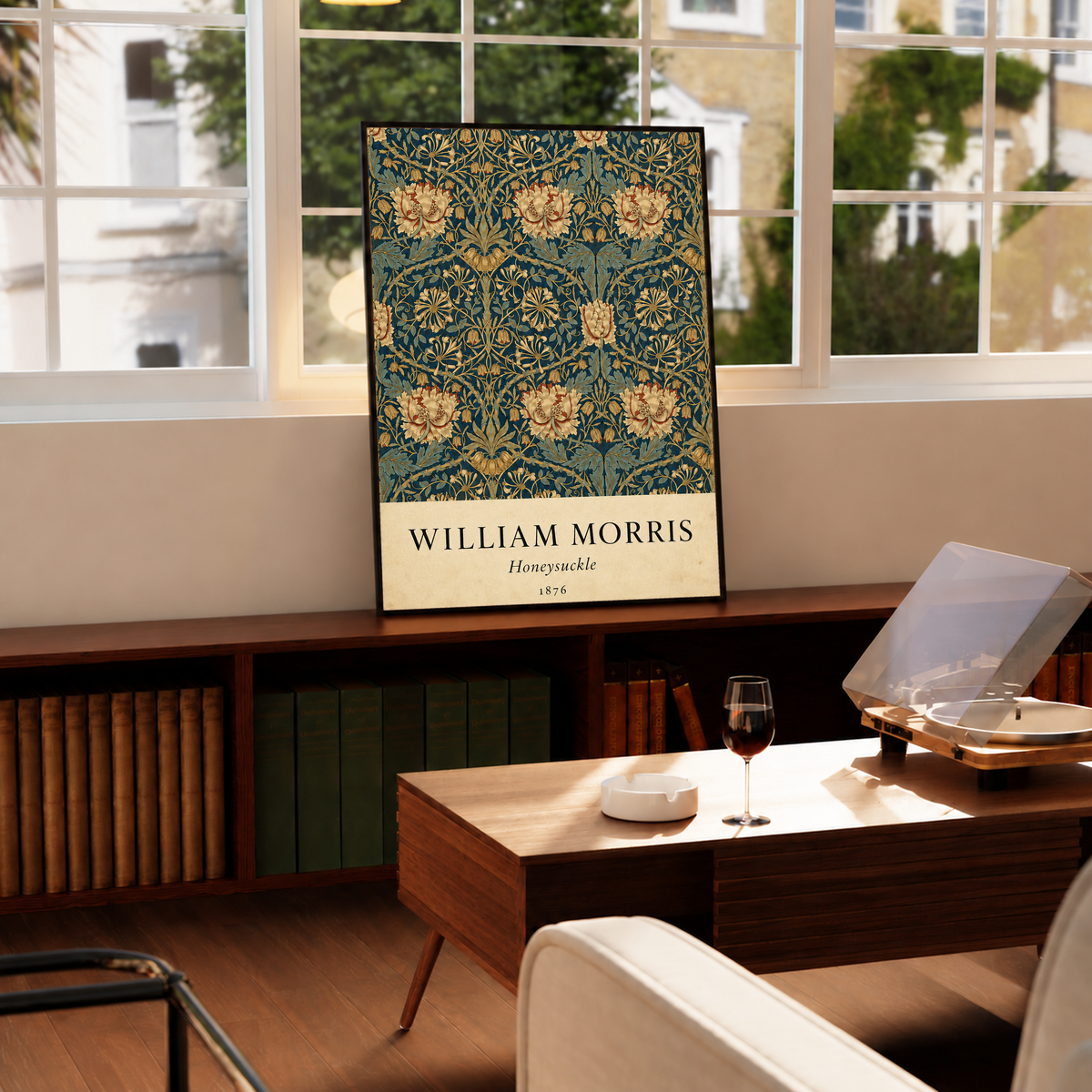 William Morris Honeysuckle floral pattern with gold and pink blooms on dark teal in a black frame on a cabinet beside a window and record player