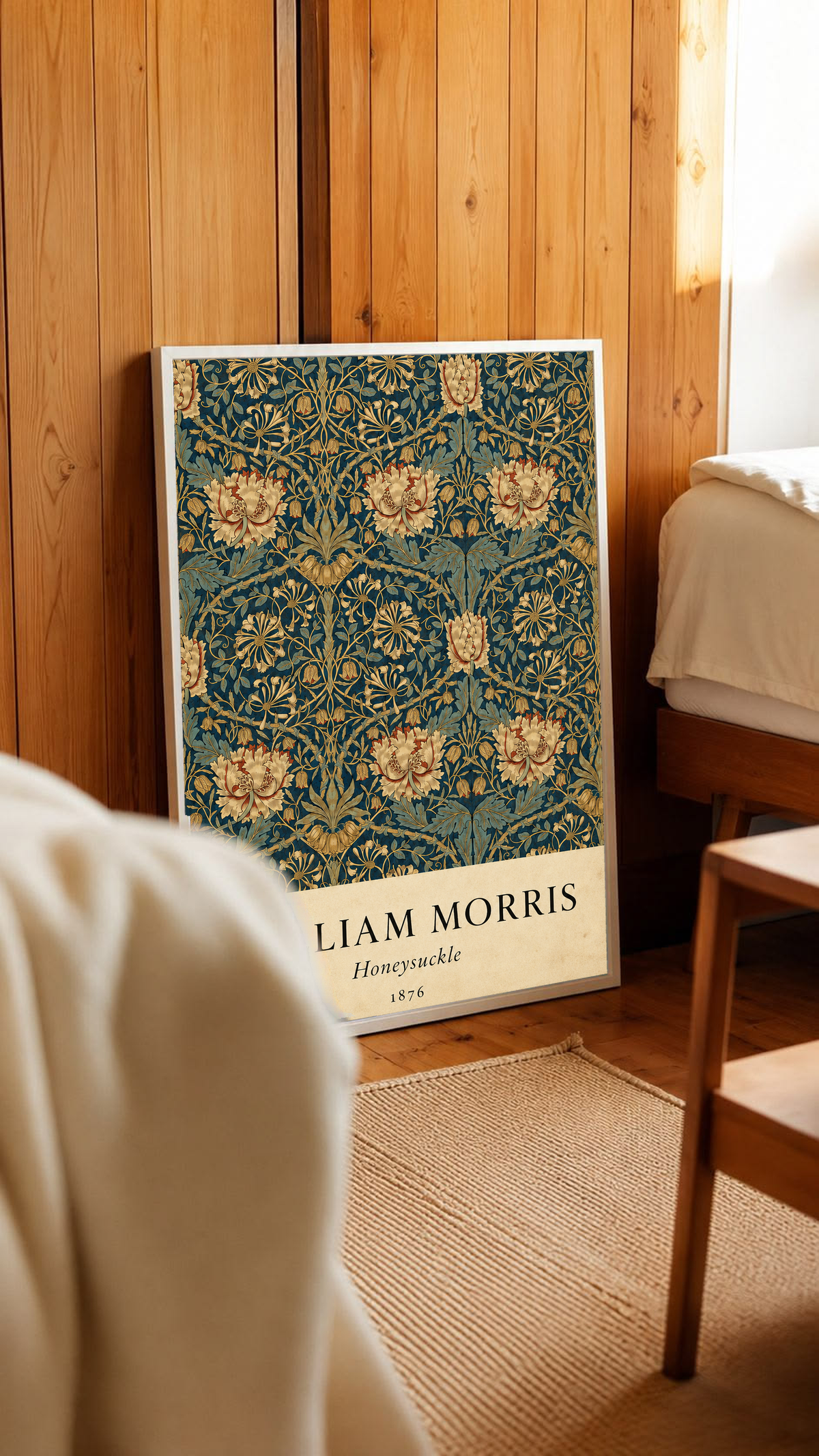 William Morris Honeysuckle floral pattern with gold and pink blooms on dark teal in a white frame in a wood-panelled bedroom