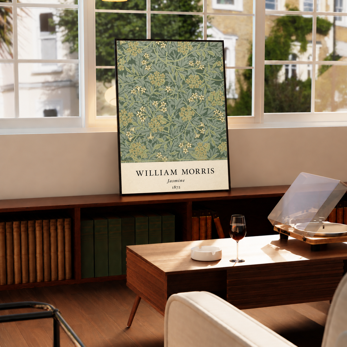 William Morris Jasmine sage and olive foliage with pale yellow flowers in a black frame on a cabinet beside a window and record player