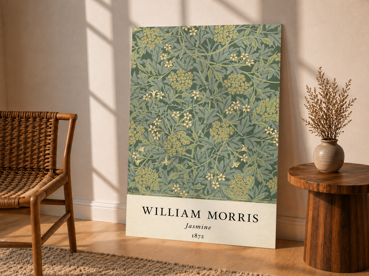 William Morris Jasmine sage and olive foliage with pale yellow flowers as an unframed display leaning beside a wicker chair and side table