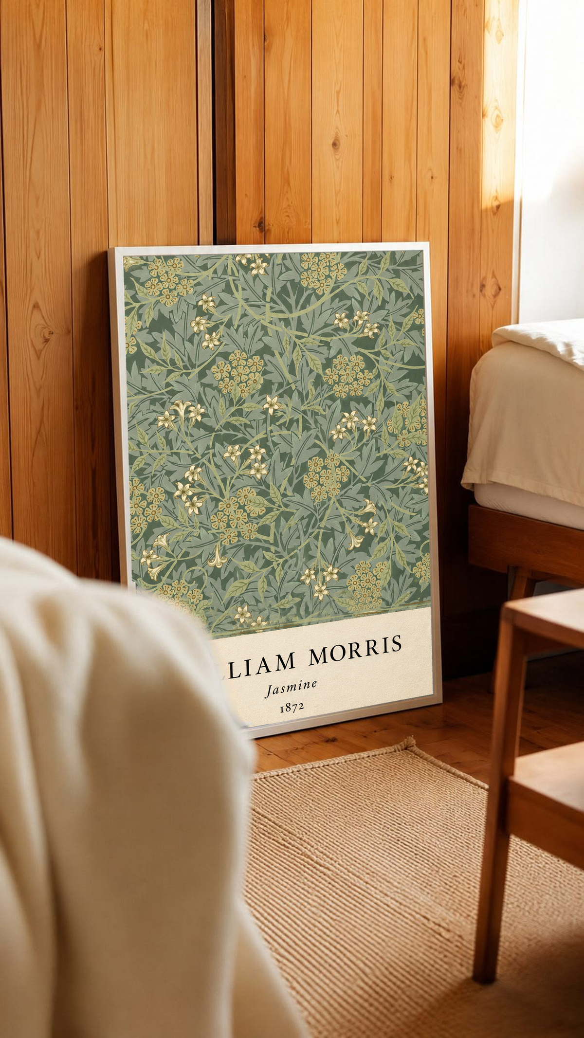 William Morris Jasmine sage and olive foliage with pale yellow flowers in a white frame in a wood-panelled bedroom