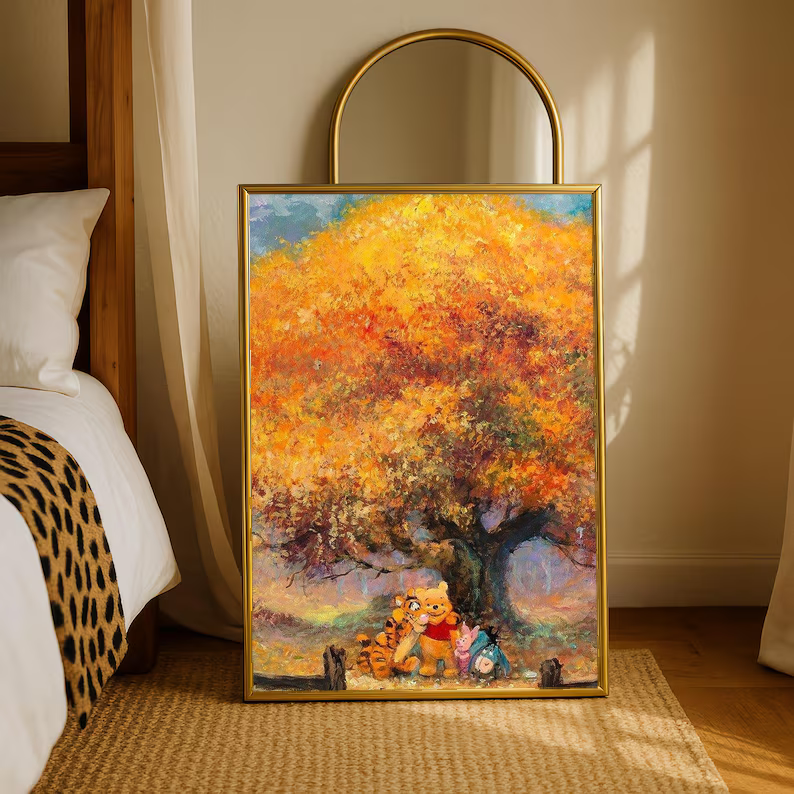 Gold-framed autumn tree art print with golden leaves and Pooh & friends on easel