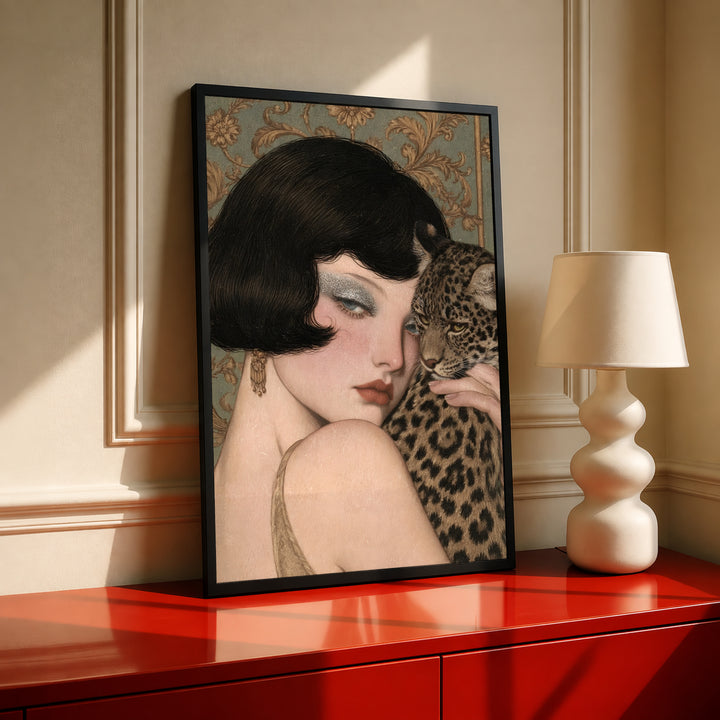 Framed leopard-and-woman portrait in black frame displayed on a red console table
