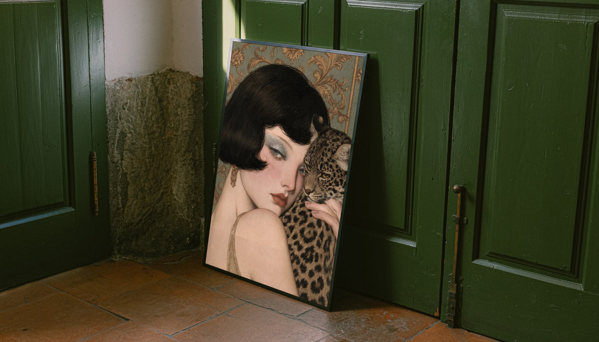 Portrait print with dark frame leaning against green doors of a pale woman and leopard