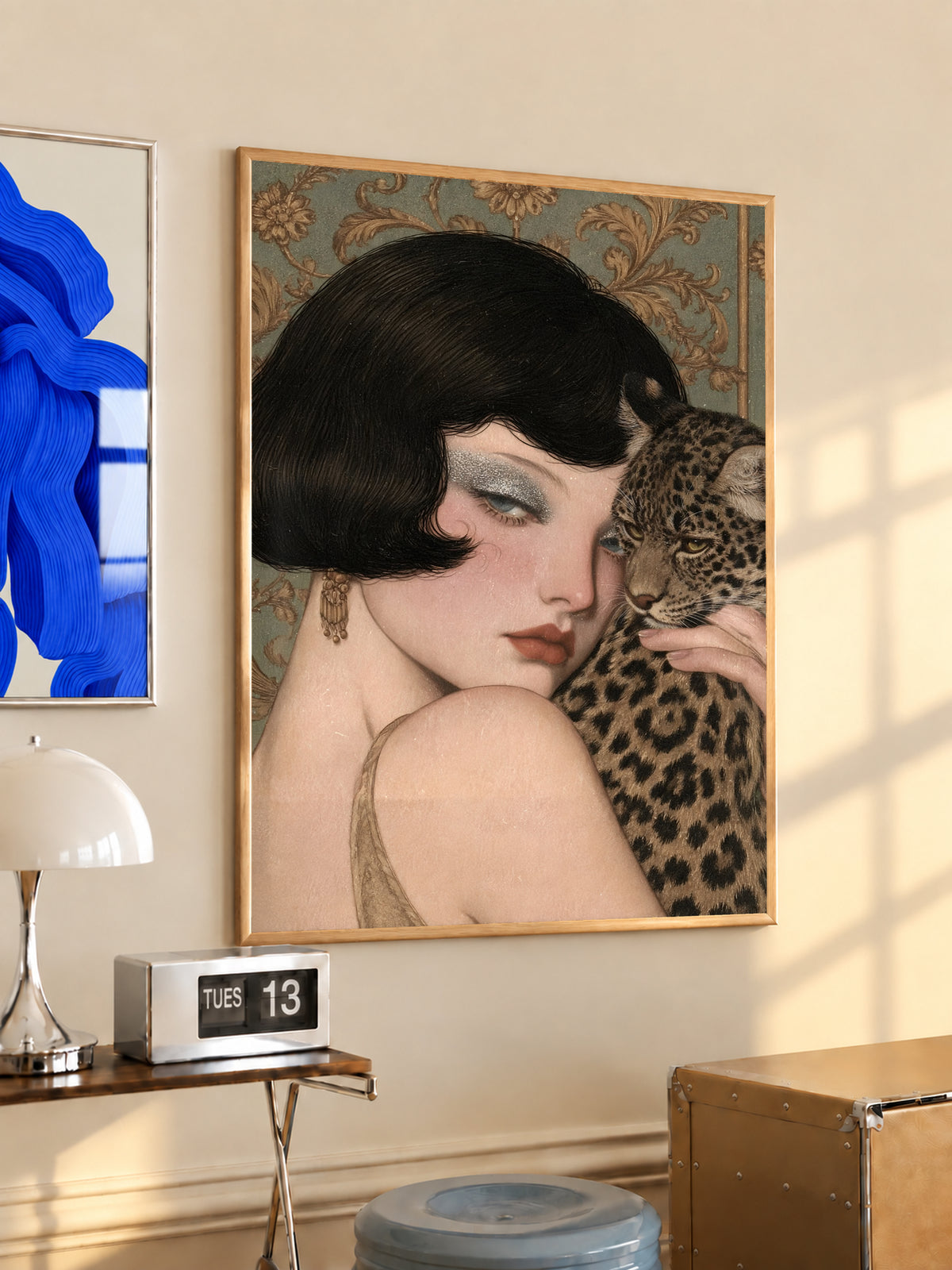 Gold-framed portrait art of a pale woman in vintage style holding a leopard