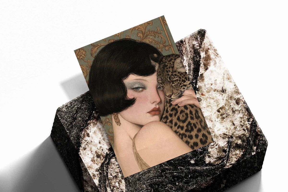Laid flat framed print showing a vintage pale woman holding a spotted leopard