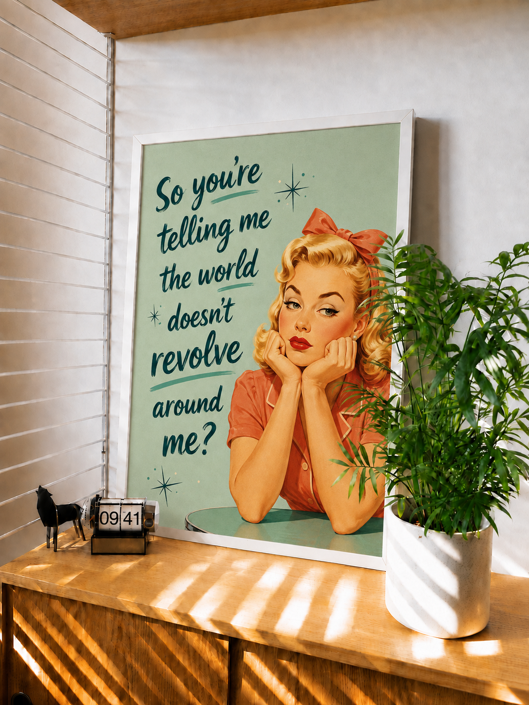 White-framed retro wall art print with blonde woman and quote on teal background