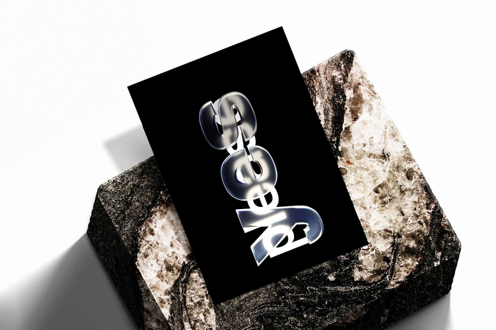 Yes Please lettering with reflective silver yes and overlapping white please on black, shown as an unframed print tilted on a dark stone display against a light background