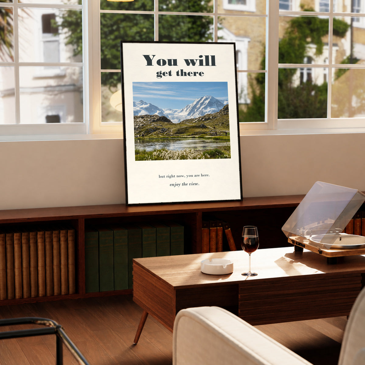 Black-framed poster featuring a mountain lake and motivational text