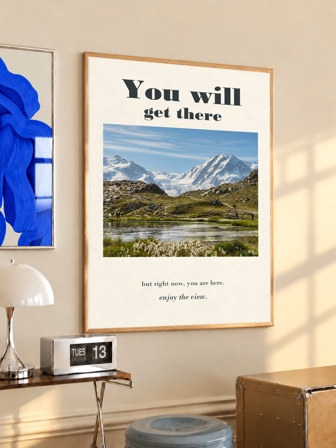 Mountain lake poster in a light wood frame with motivational text